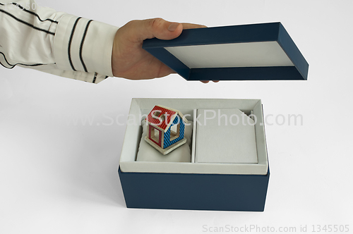 Image of Gift box with house inside