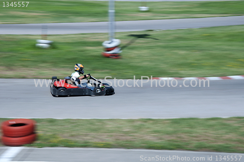 Image of Boy drive car on kart track