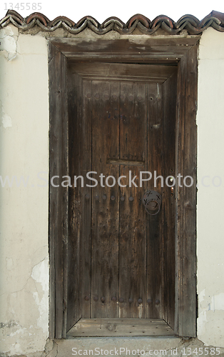 Image of Old brown wooden vertical door