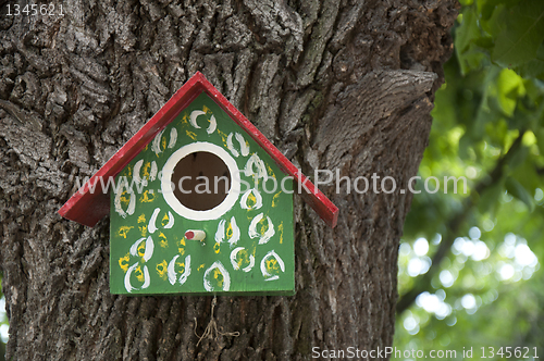 Image of Home-made bright colored bird house. 