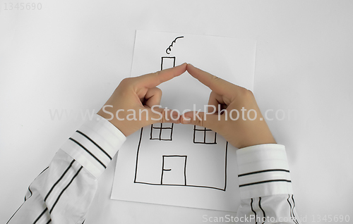 Image of Painted house and two hands for roof