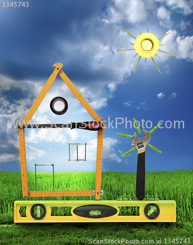 Image of House with tree and sun made of tools for building.White isolate