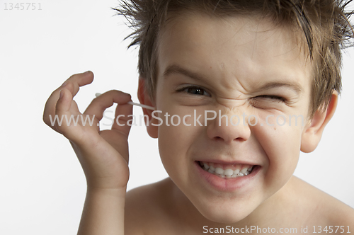 Image of Boy cleans his ear