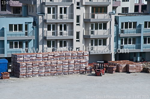 Image of Pallets of bricks in front of new building