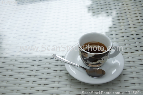 Image of Cup of coffee on white table. 