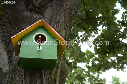 Image of Home-made bright colored bird house 