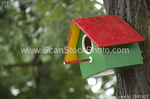Image of Home-made bright colored bird house 