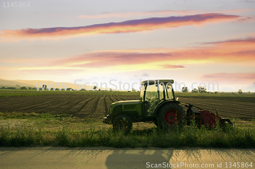Image of Plowed land and tractor 