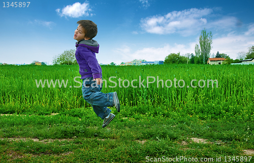 Image of Jumped boy on green meadow