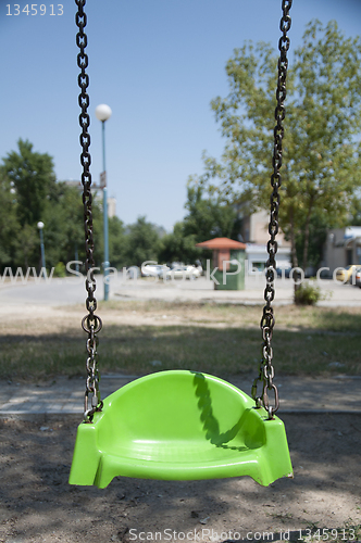 Image of Empty green swing with chain