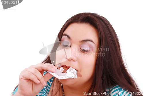 Image of Crazy for chocolate, pretty young woman eating chocolate