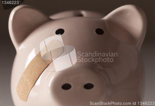 Image of Piggy Bank with Bandage on Face