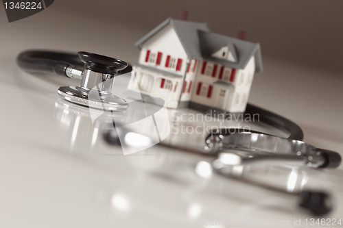 Image of Stethoscope with Small Model Home