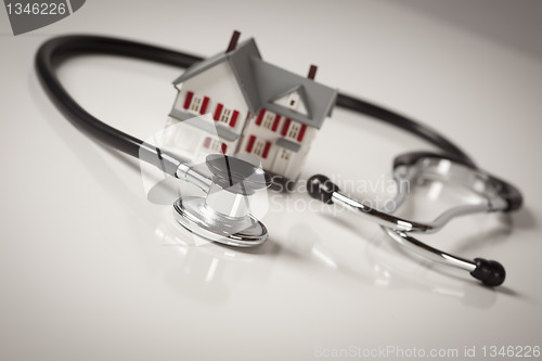 Image of Stethoscope with Small Model Home