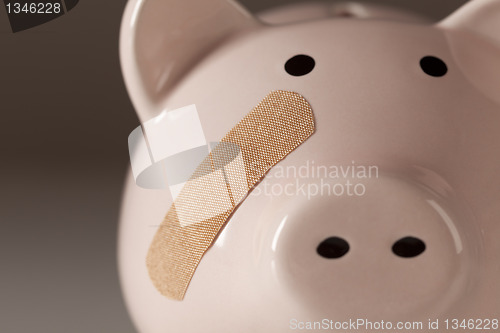 Image of Piggy Bank with Bandage on Face