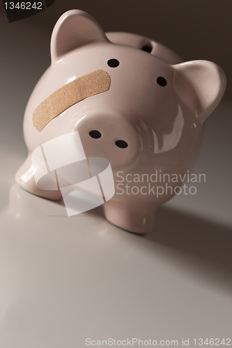 Image of Piggy Bank with Bandage on Face