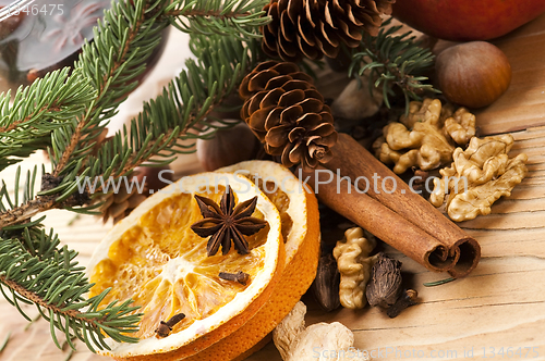 Image of Different kinds of spices, nuts and dried oranges - christmas de