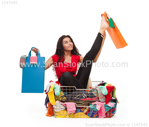 Image of Woman in flexible pose with shopping bags