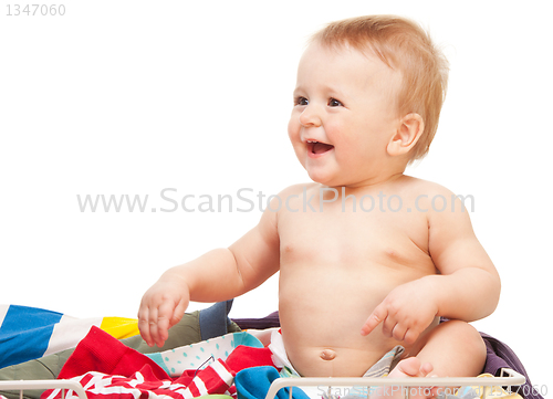 Image of Laughing baby sitting in clothes