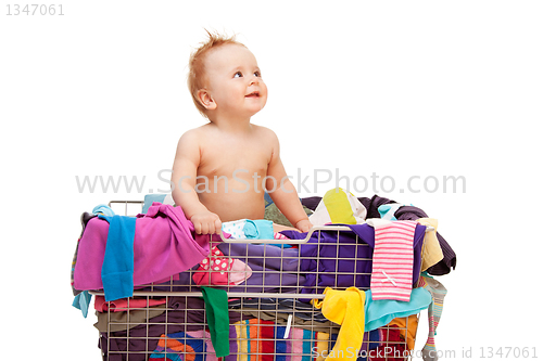 Image of Baby in basket with clothes