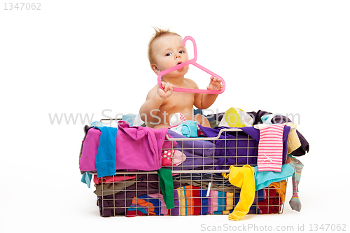 Image of Baby in clothes and hanger