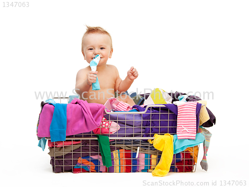 Image of Toddler in basket with clothes