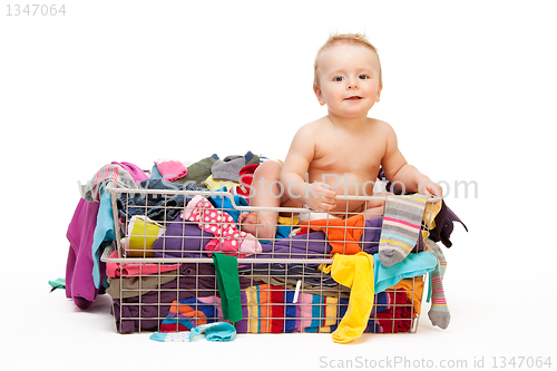 Image of Happy baby in basket with clothes
