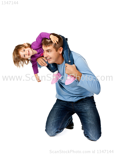 Image of Happy father holding daughter on his shoulders