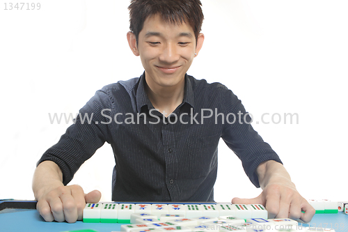 Image of Chinese man play Mahjong, traditional China gamble. 