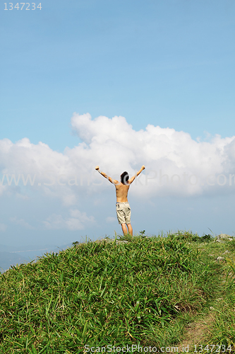 Image of Meeting of the sky. The man on high mountain with the hands lift