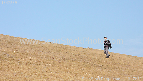 Image of man walking on the mountain