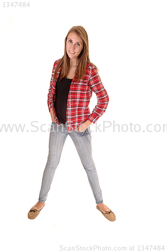 Image of Girl in jeans standing.