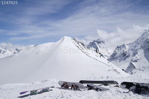 Image of Snowboards against the top of mountain