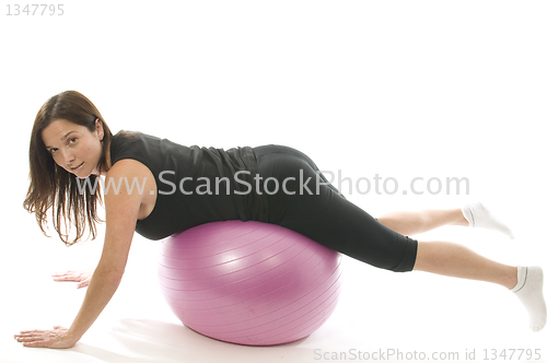 Image of pretty woman exercising core training ball push-ups