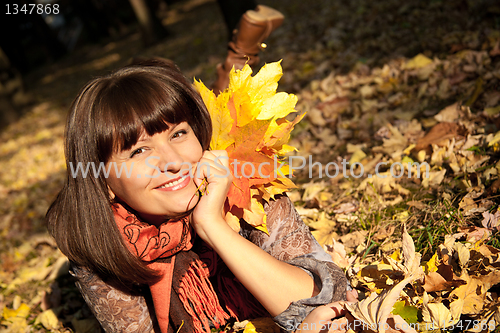 Image of woman with autumn leaves