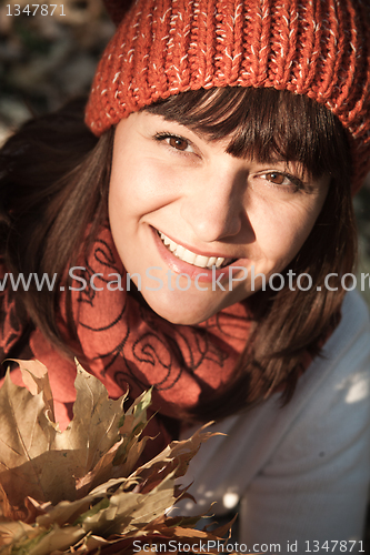 Image of woman with autumn orange leaves