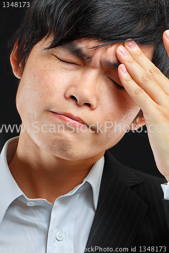 Image of Tired business man holding his head