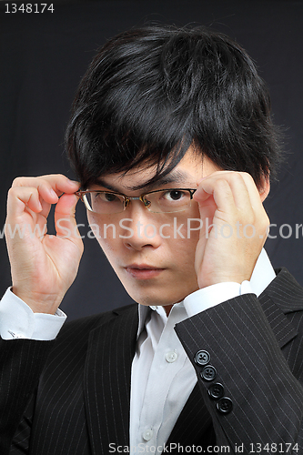 Image of Closeup portrait of a asian young man wearing spectacles against