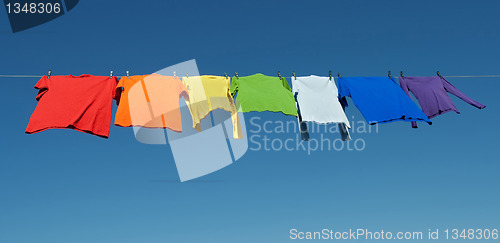 Image of Rainbow laundry, bright shirts on a clothesline