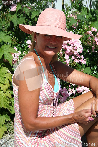 Image of Smiling girl among roses