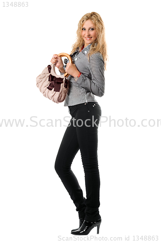 Image of Cheerful young blonde with a handbag. Isolated