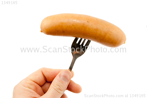 Image of Sausage on a fork isolated on white 