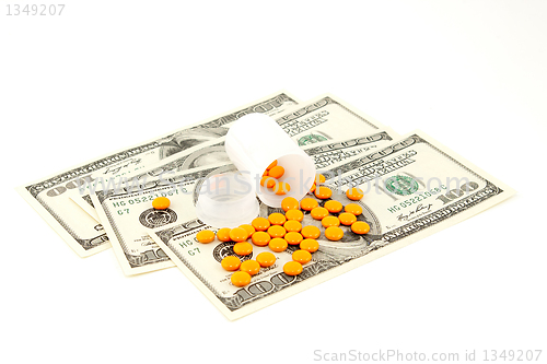 Image of orange pill at the money , isolated on white background 