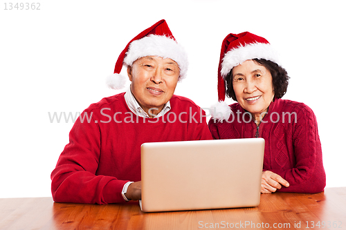 Image of Senior Asian grandparents using computer