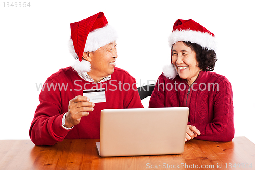 Image of Senior Asian couple shopping online celebrating Christmas