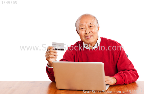 Image of Senior Asian man shopping online celebrating Christmas