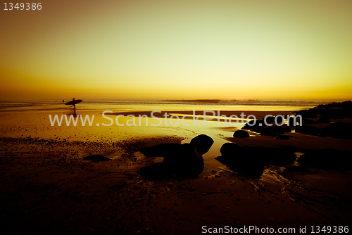 Image of Surfers walking in the beach