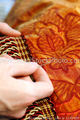 Image of Craftsman hands working on a curtain