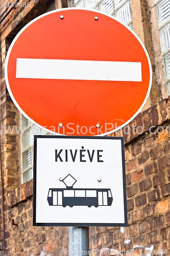 Image of Do not cross sign with  strange vehicle
