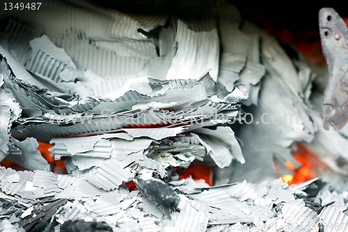 Image of Paper burning in recycle barrel